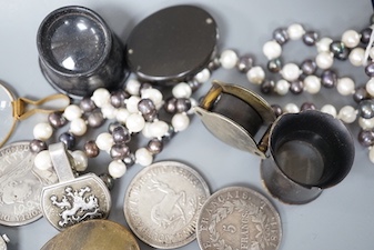 A collection of coins, magnifying loupes, cultured pearl necklace, etc.